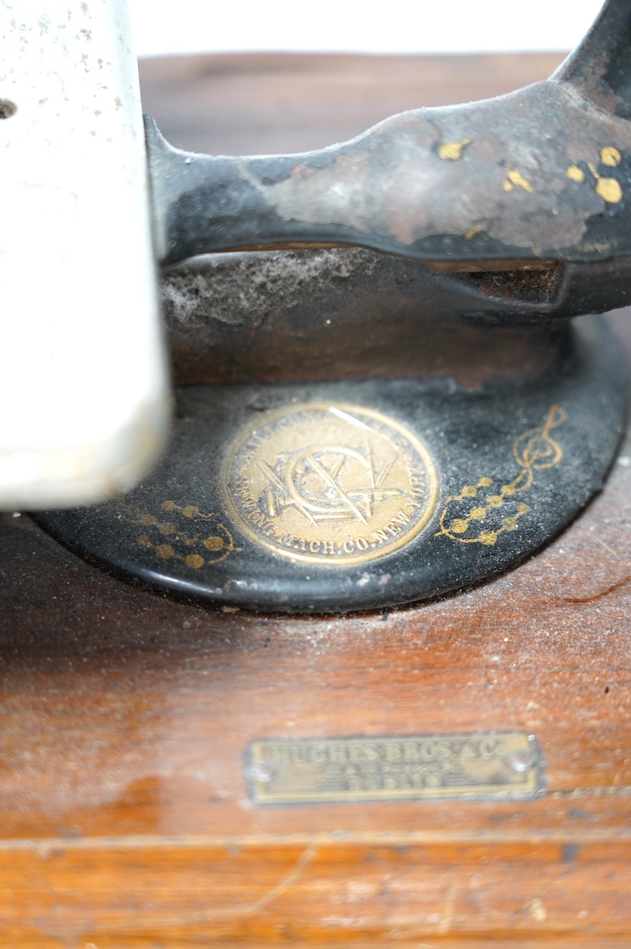 A late 19th century Wilcox and Gibbs sewing machine on a mahogany base. Condition - fair